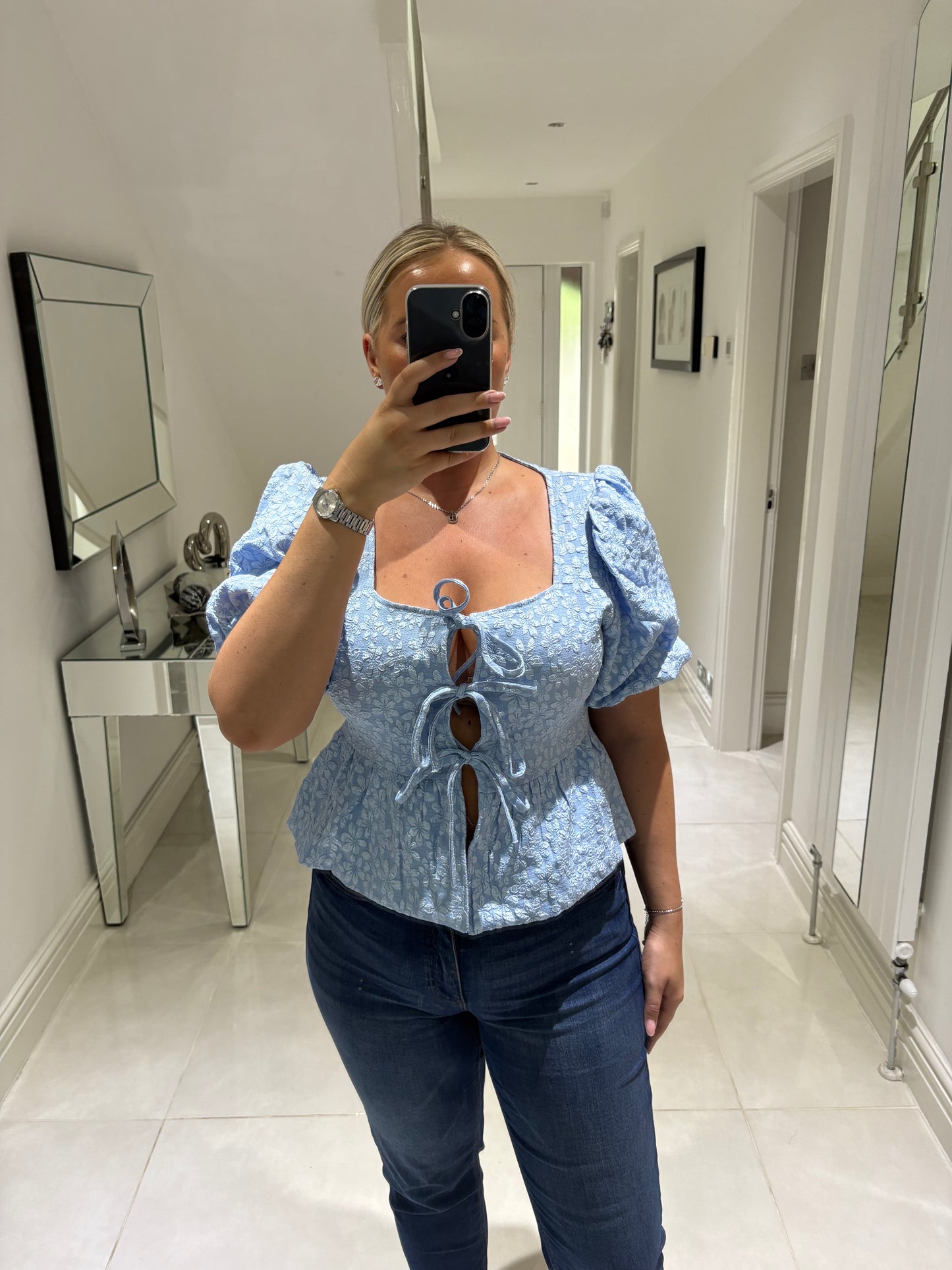CARLY BOW PEPLUM TOP