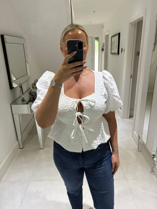 CARLY BOW PEPLUM TOP
